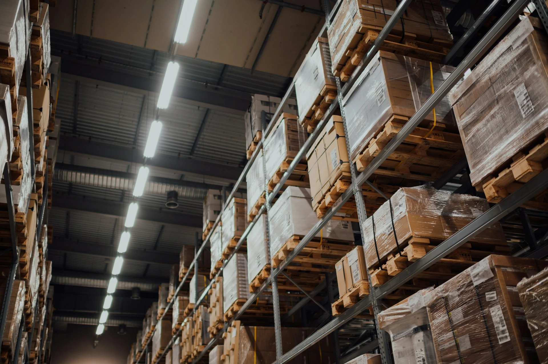 Order boxes stacked on a metal shelf unit in a clothing wholesale warehouse