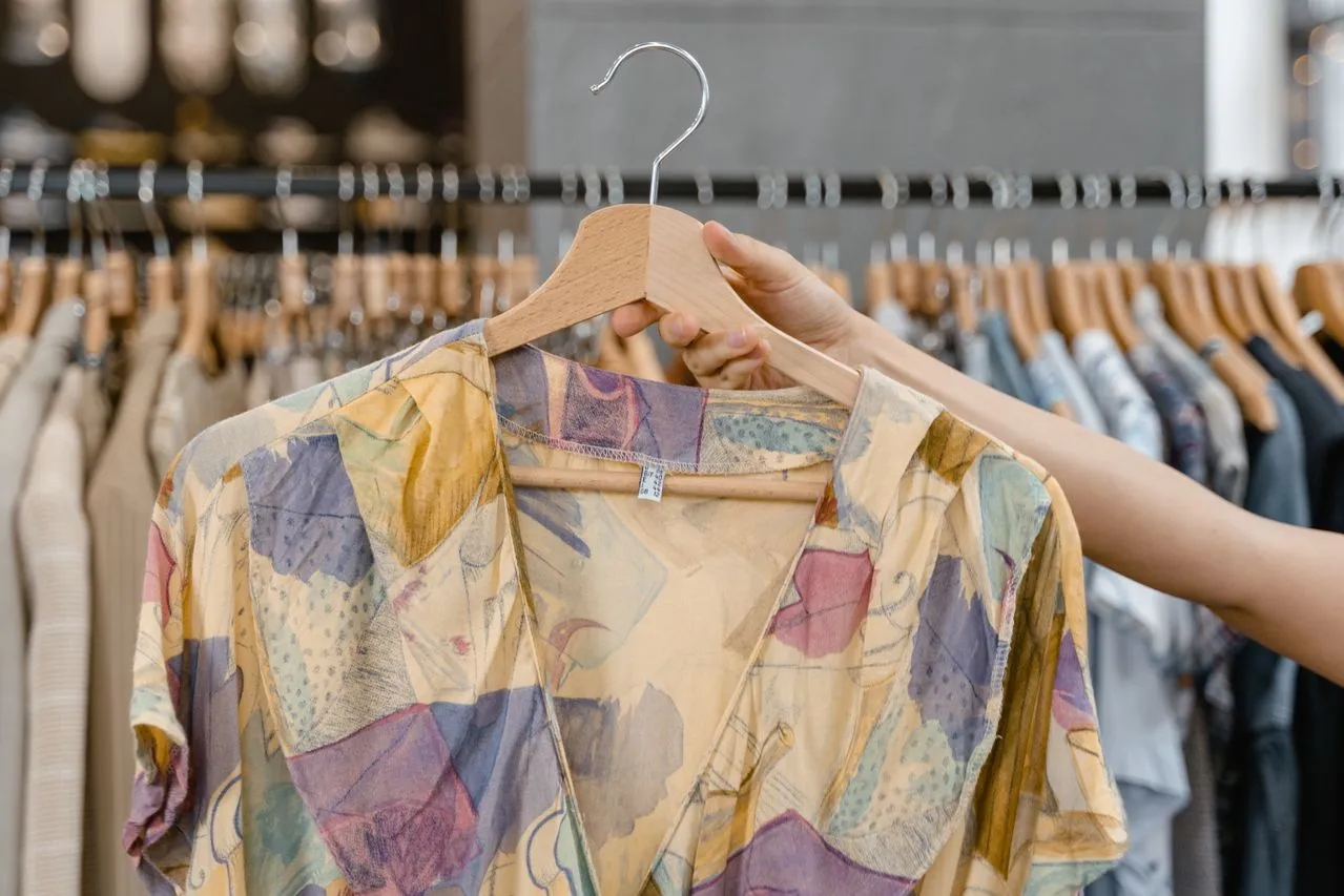 Customer browsing used clothing in the vintage and streetwear segment